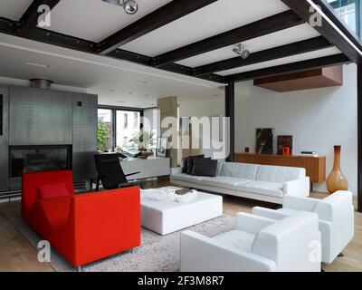 Open plan living area with modern sofas and chairs in French residential home. Stock Photo