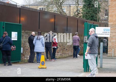 London, UK, 17 March 2021: As the total number of people to have received at least one coronavirus vaccination passed 25 million, people queue at a GP surgery in Lambeth to receive their's. All people over the age of 50 can now book an appointment without waiting for an invitation from their GP. The NHS has rolled out the vaccination programme at unprecedented speed and people are being reassured that the risks from the AstraZenica vaccine are minimal. Anna Watson/Alamy Live News Stock Photo