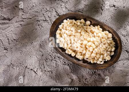 White threshed corn in the wooden bowl - Zea mays Stock Photo