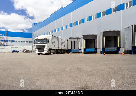 Truck while loading in a big distribution warehouse with gates for for loading goods and trucks Stock Photo