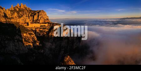 Montserrat and the Montserrat abbey at sunrise, from the Creu de Sant Miquel viewpoint (Barcelona province, Catalonia, Spain) Stock Photo