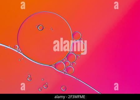 macro photography of small bubbles on a red-orange background. Stock Photo