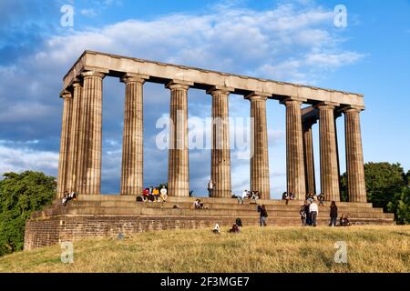 Edinburgh, UK - Aug 9, 2012: Tourists enjoy sunny evening at the National Monument of Scotland on the Calton Hill Stock Photo