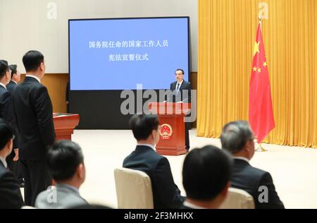 (210317) -- BEIJING, March 17, 2021 (Xinhua) -- Senior officials of departments and units under the State Council take an oath of allegiance to the Constitution at a ceremony in Beijing, capital of China, March 17, 2021. The ceremony was overseen by Premier Li Keqiang. (Xinhua/Pang Xinglei) Stock Photo