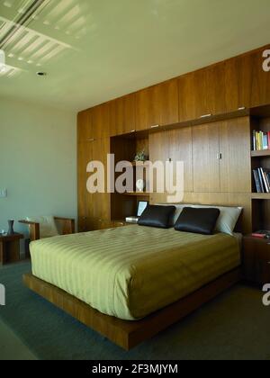 Double bed in bedroom with fitted wardrobes in USA home Stock Photo