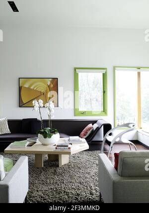 Seating around coffee table in living room of USA home Stock Photo