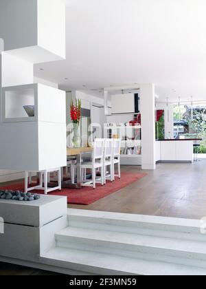 View of dining area and kitchen in spacious open plan room in UK home
