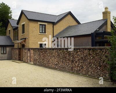 Log store outside UK home Stock Photo