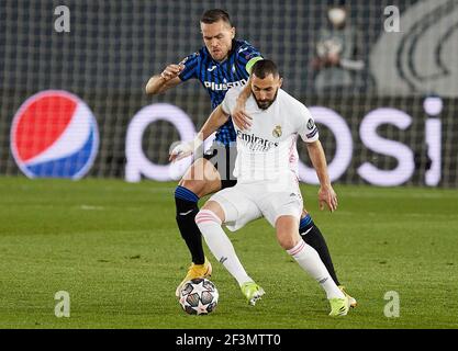 Madrid, Spain. 16th Mar, 2021. Karim Benzema (Real Madrid CF) and Rafael Toloi (Atalanta Bergamo) battle for the ball during the UEFA Champions League round of 16 second leg match between Real Madrid and Atalanta Bergamo at Valdebebas Sport City in Madrid.(Final score; 3 to 1 for Real Madrid, qualifying in a global of the 4-1 tie) (Photo by Manu Reino/SOPA Images/Sipa USA) Credit: Sipa USA/Alamy Live News Stock Photo