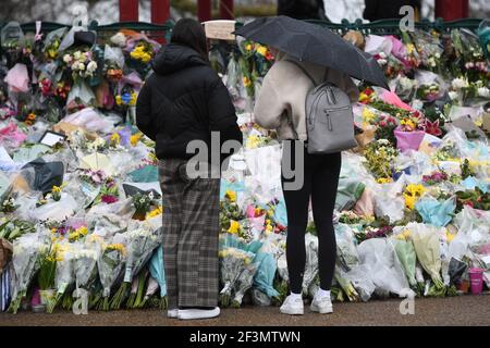 Women looks at floral tributes left next to the bandstand in Clapham Common, London, for Sarah Everard. Pc Wayne Couzens, 48, appeared at the Old Bailey in London charged with the kidnap and murder of the 33-year-old. Picture date: Tuesday March 16, 2021.