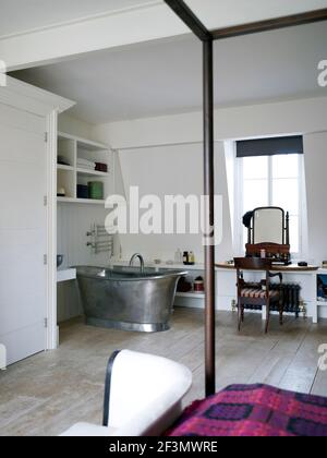 Freestanding bathtub in bedroom in UK home Stock Photo