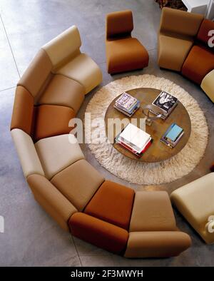 View from above of spacious, daylight-lit spiral staircase with beige ...