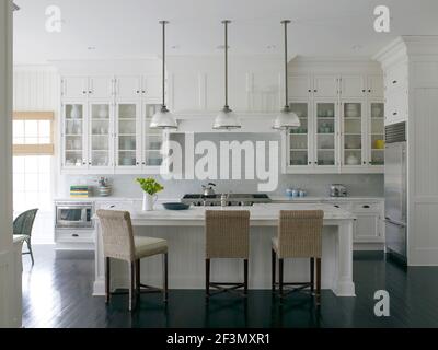 Bar stools at breakfast bar in kitchen in USA home Stock Photo