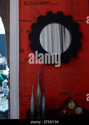Black mirror on red wall in French home Stock Photo