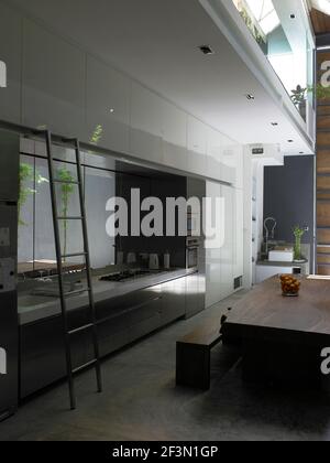 Table and chairs in spacious open plan kitchen in Singaporean home Stock Photo