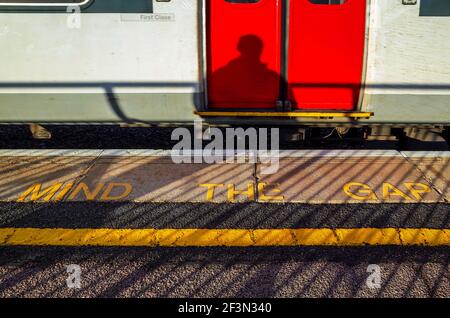 Mind the Gap sign on a mainline railway station platform. Stock Photo