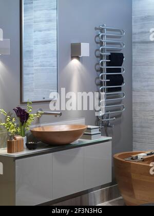 Wooden washbasin on unit in modern bathroom, UK home Stock Photo