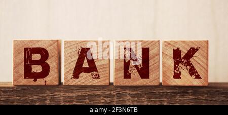 Bank word concept written on wooden cubes on wooden table. Banking saving financial investment concept. Stock Photo
