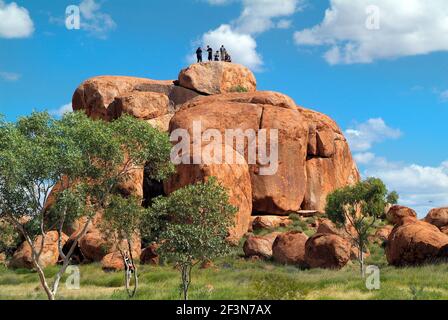 Waramungu, Australia April 19, 2010: Unidentified tourists on top of natural landmark and Aborigines sacred site Devils Marbles in Northern Territory