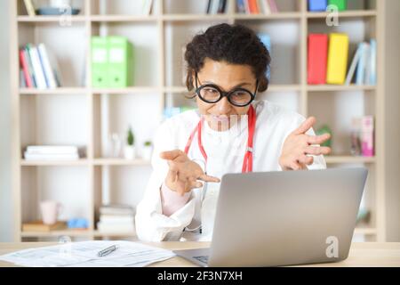 Doctor helping patient via telehealth making video call