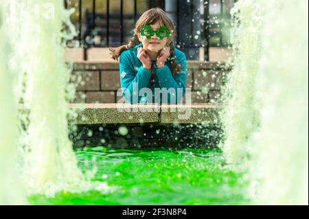 Bantry, West Cork, Ireland. 17th Mar, 2021. Although all the St. Patrick's Day parades in Ireland were cancelled due to COVID-19, that didn't stop people dressing up in green for the Irish National Day. Celebrating at Bantry's green pool and fountains was 7 year old Alexandra Bak. Credit: AG News/Alamy Live News Stock Photo