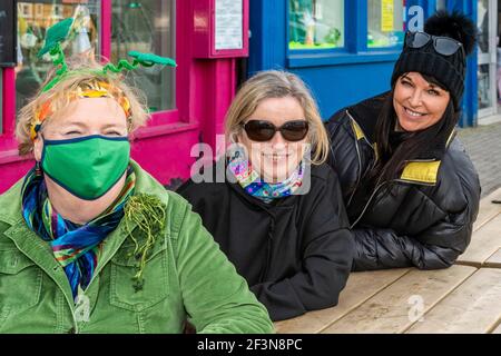 Bantry, West Cork, Ireland. 17th Mar, 2021. Although all the St. Patrick's Day parades in Ireland were cancelled due to COVID-19, that didn't stop people dressing up in green for the Irish National Day. Enjoying the day were sisters Eileen and Susan O'Sullivan and Martina Wiseman, all from Bantry. Credit: AG News/Alamy Live News Stock Photo