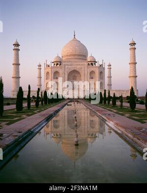 The Taj Mahal is a mausoleum located in Agra, India. The Mughal Emperor Shah Jahan commissioned it as a mausoleum for his favourite wife, Mumtaz. Cons Stock Photo