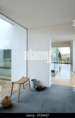 Looking from the glazed entrance hall through to the main living space + Vicky Peirson on the balcony - Stan Bolt Architect (www.stanboltarchitect.com Stock Photo