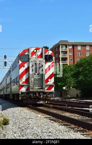 Morton Grove, Illinois, USA. A Metra commuter train leaving a suburban station on its journey to downtown Chicago. Stock Photo