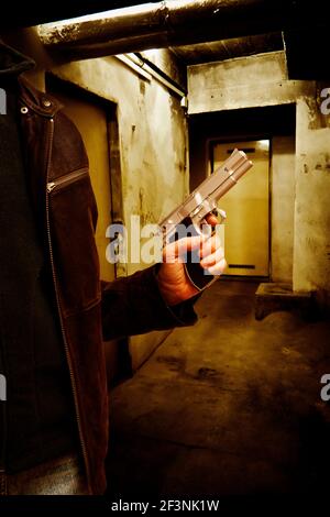 man with a gun in hand, mystery crime image for book cover Stock Photo