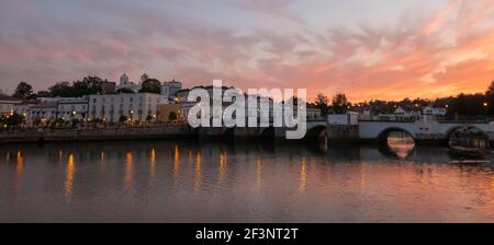 Sunset over the Roman Bridge across the River Gilao in Tavira, Eastern Algarve, Portugal Stock Photo