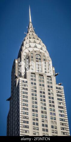The spire of the Chrysler Building (1928-1930), in Manhattan. The tower's art-deco styling and grotesques (similar to gargoyles) resemble the elaborat Stock Photo