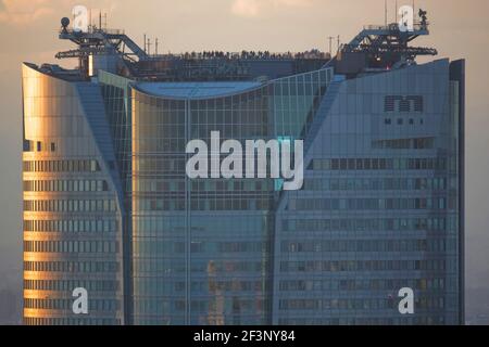 A telephoto view at twilight captures a crowd of visitors on the rooftop observatory of Mori Tower (54-storey) in the Roppongi Hills business complex, Stock Photo