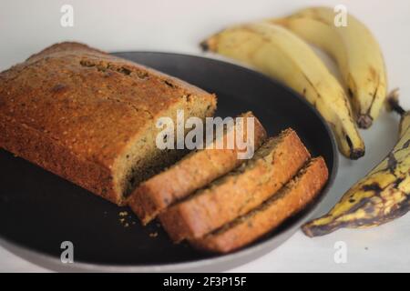 Slices of home baked whole wheat ripe plantain cake. It is also called ripe plantain bread. Shot on a white background Stock Photo