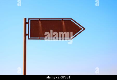 Empty arrow sign for mockup, on clear blue sky, copy space Stock Photo