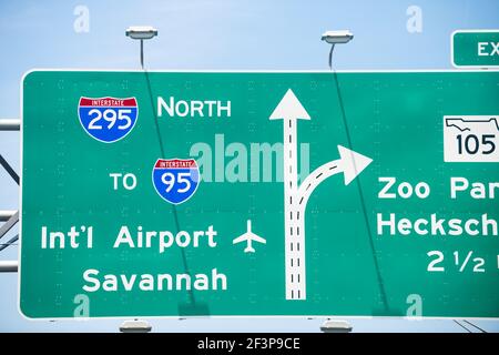 Jacksonville, Florida interstate highway 295 with traffic road sign to i-95 international airport of Savannah and Zoo parkway with cars driving in sum