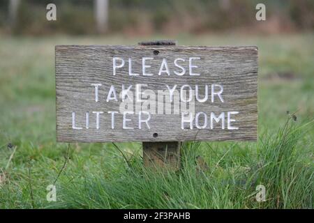 Please Take Your Litter Home Wooden Sign On Ashdown Forest - Countryside Climate Change - Recycle Your Rubbish - White Letters Wooden Sign - Sussex UK Stock Photo