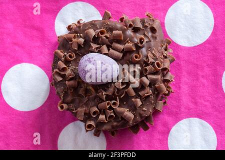 Cadbury Mini Eggs Nest Cake set on pink polka dot serviette napkin Stock Photo