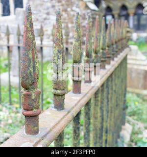 Rusty iron railing spikes in a church yard Stock Photo