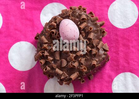 Cadbury Mini Eggs Nest Cake set on pink polka dot serviette napkin Stock Photo
