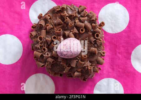 Cadbury Mini Eggs Nest Cake set on pink polka dot serviette napkin Stock Photo
