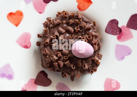 Cadbury Mini Eggs Nest Cake set on plate with hearts on Stock Photo