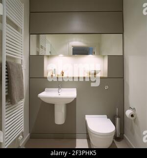 Wall mounted washbasin next to toilet in modern bathroom Stock Photo