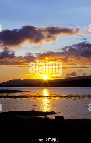 A sunset across Loch na Cille to the Keillmore Peninsula viewed from Danna, Knapdale, Argyll & Bute, Scotland UK Stock Photo