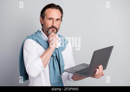 Photo portrait of thoughtful freelancer programmer working on computer wearing spectacles isolated pastel grey color background Stock Photo