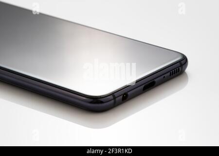 Mobile cell phone on white acrylic table for presentation product photography. Stock Photo
