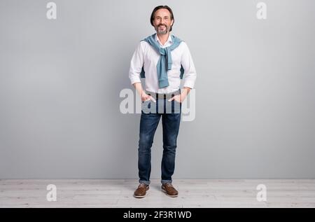 Full length body size photo of man wearing white shirt jeans brown shoes spectacles isolated on pastel grey color background Stock Photo