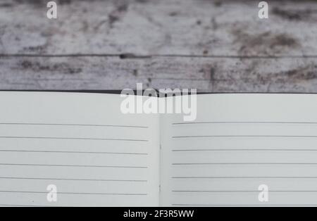 Open book with blank pages on a wooden surface Stock Photo