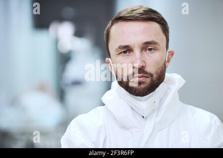 Portrait of mature male doctor at hospital looking at camera Stock Photo