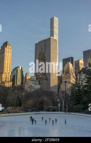 Skyscrapers overlooking Central Park, with Wollman rink in foregroundNew York, New York Stock Photo